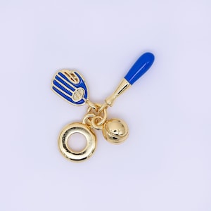May include: A gold-toned baseball charm featuring a blue and gold baseball glove, a blue and gold baseball bat, a baseball, and a ring. The charm is designed with intricate details and a polished finish.