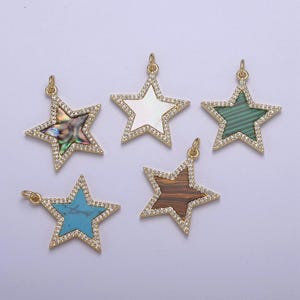 May include: Five gold star-shaped pendants with different colored stone inlays. The stones are turquoise, brown, green, white, and iridescent.