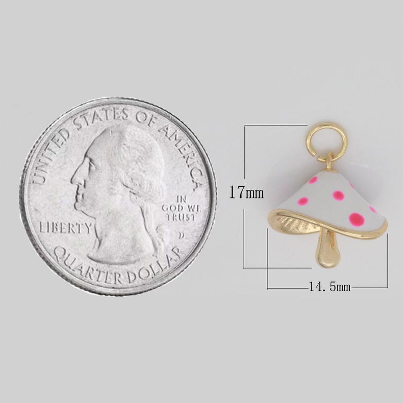 May include: Gold-tone mushroom charm with white enamel and pink polka dots. The charm is 17 mm tall and 14.5 mm wide.