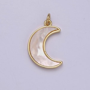 May include: A gold-toned crescent moon charm with a white mother-of-pearl inlay.