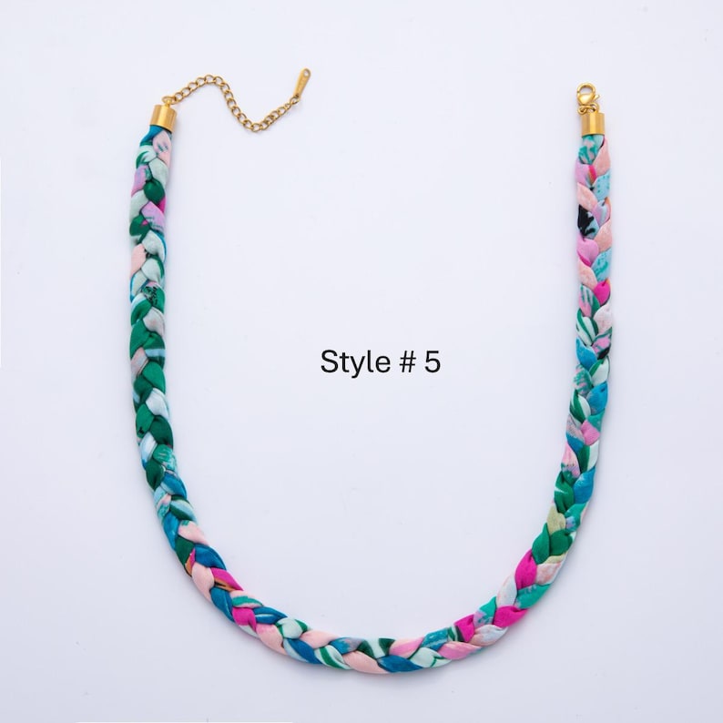 May include: Braided fabric necklace in shades of green, blue, pink, and white, with gold-colored metal clasps and chain. The text "Style #5" is printed on the image. This necklace is a fashion accessory.