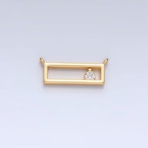 May include: A gold pendant necklace with a rectangular frame and a single clear diamond in the center.