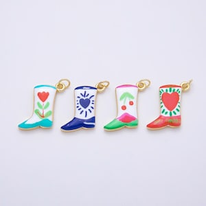 May include: Four metal boot charms with gold-tone jump rings. The first is white with a red flower, the second is blue and white with a heart, the third is white with red cherries and a green base, and the fourth is white with a large red heart.