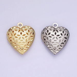 May include: Two heart-shaped locket pendants, one gold and one silver, with intricate cut-out designs.
