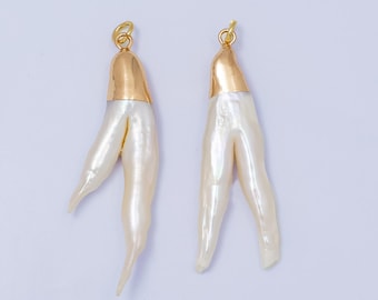 May include: Two white pearl chicken foot charms with gold tops. The charms are about 2 inches long.