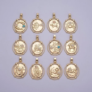 May include: Gold-colored zodiac pendant necklaces. Each pendant features a different zodiac symbol within a textured oval frame, with a small, round, colored stone accent. The pendants are arranged in a grid pattern.