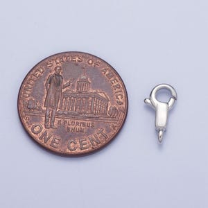 May include: Silver-toned lobster clasp for jewellery making. The clasp is about the size of a UK penny.