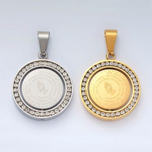 May include: Two silver and gold pendants with a circular design. The pendants feature a praying hands image and a quote that reads: "God, grant me the courage to change the things I can, the wisdom to know the things I cannot change, and the serenity to accept the things I cannot change."