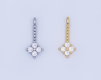 May include: Two pendant necklaces, one silver-toned and one gold-toned, each featuring a four-leaf clover design with clear, round gemstones. The pendants hang from a chain of small, round beads, creating a delicate and elegant look.
