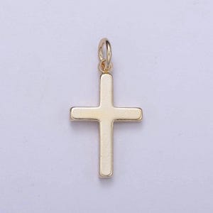 May include: A gold-colored cross charm pendant. The cross is simple and flat, with a smooth surface.