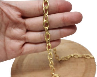 May include: A gold chain necklace with a textured finish. The chain is made of oval links and is approximately 18 inches long.
