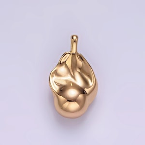 May include: A gold-colored pendant shaped like a smooth, abstract blob with a loop at the top for attaching a chain.