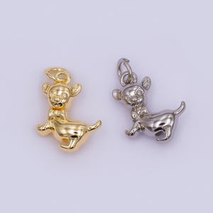 May include: Two metal charms shaped like a deer. One is gold-colored, the other is silver. Each charm has a bow tie and a loop at the top for attaching to a necklace or bracelet. The deer are in a running pose.