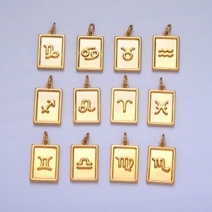 May include: Twelve gold-colored zodiac sign charms, each with a different astrological symbol. The charms are in a rectangular shape with rounded corners and are arranged in three rows of four.