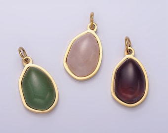 May include: Three gold-toned pendants with different colored stones. The pendants are shaped like teardrops and have a smooth, polished finish. The stones are pink, green, and purple.