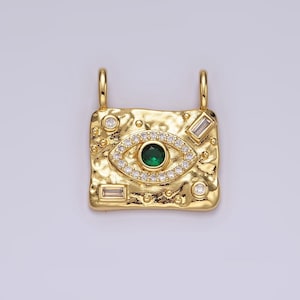 May include: Gold pendant with a green eye charm surrounded by clear rhinestones. The pendant has a textured, hammered finish and is decorated with additional clear rhinestones.