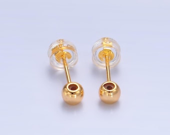 May include: A pair of gold ball stud earrings with clear plastic backs.