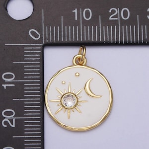 May include: Gold-tone pendant charm with a white enamel circle featuring a sun with a clear rhinestone center, a crescent moon, and three small stars.