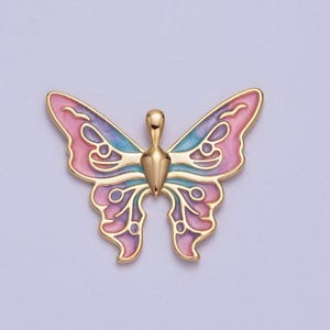 May include: A gold-tone butterfly charm with pink, purple, and blue enamel. The butterfly has a detailed design with intricate wings.