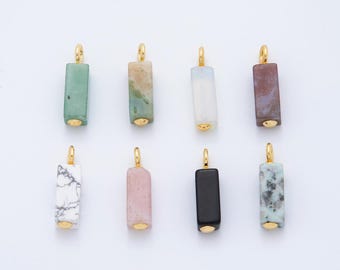 May include: Eight rectangular gemstone pendants with gold-colored metal accents. The pendants vary in color, including green, beige, white, purple, pink, and black. Each pendant has a gold loop at the top for hanging.