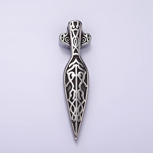 May include: A silver pendant in the shape of a spearhead with intricate Celtic knotwork designs.