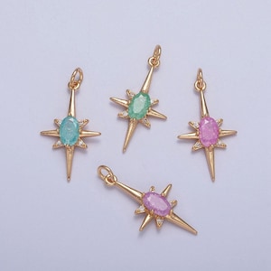 May include: Four gold starburst pendants with a single gemstone in the center. The gemstones are green, pink, and purple.