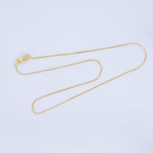 Puede incluir: Un collar de cadena de oro con cierre de langosta.