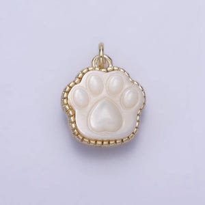 May include: Gold-tone charm with a white, mother-of-pearl paw print design.