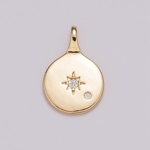 May include: Gold pendant charm featuring a small diamond set within a starburst design.