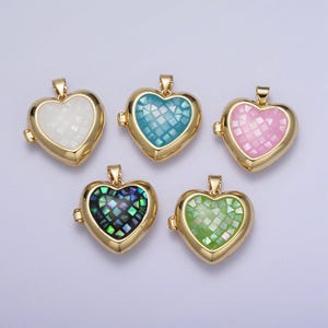 May include: Five gold heart-shaped locket pendants with different colored mosaic inlays. The lockets are open and have a hinge on the side. The colors of the inlays are white, blue, pink, green, and black.