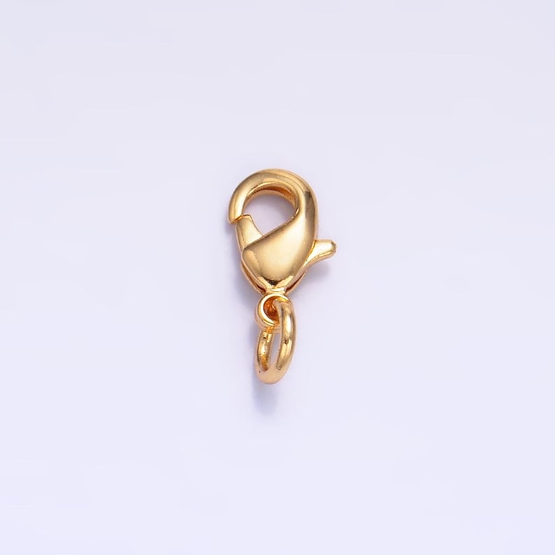 May include: Gold-toned metal lobster clasp with a ring attached. This clasp is used for jewelry making.