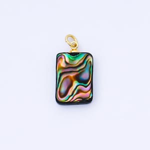 May include: A rectangular pendant with a gold-colored bail. The pendant features a vibrant, iridescent abalone shell with swirling patterns of green, blue, purple, and gold. The shell is set in a dark, possibly black, border.
