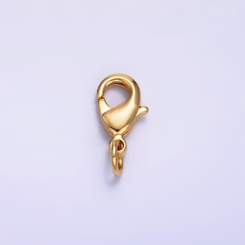 May include: Gold-toned metal lobster clasp with a spring-loaded closure. This clasp is commonly used for jewelry making and crafting.