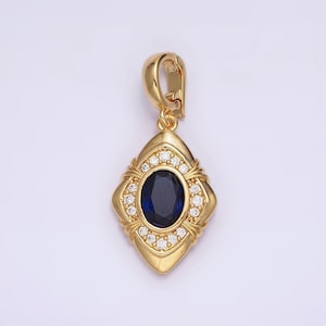 May include: A gold pendant with a blue oval gemstone surrounded by smaller clear gemstones. The pendant is in the shape of a diamond with a decorative design.