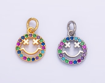 May include: Two gold and silver charm pendants with a smiley face design. The smiley faces are outlined with colorful gemstones.