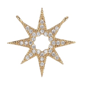 May include: A gold-toned eight-pointed star charm with clear sparkling stones.