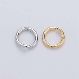 May include: Two metal jump rings, one silver and one gold. The rings are open and ready to be used for jewelry making or other crafts.