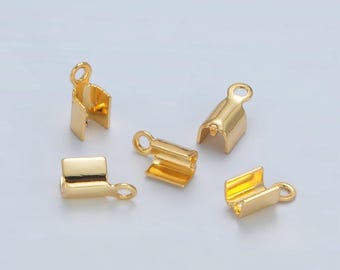 May include: Five gold-toned metal end caps for jewelry making. Each cap has a small loop at the top and a flat, rectangular base.