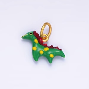 May include: A green dinosaur charm with yellow spots and a red crest. The charm has a gold loop for attaching to a necklace or bracelet.