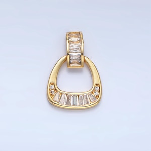May include: A gold pendant with a clear crystal design. The pendant is shaped like a horseshoe with a loop at the top.