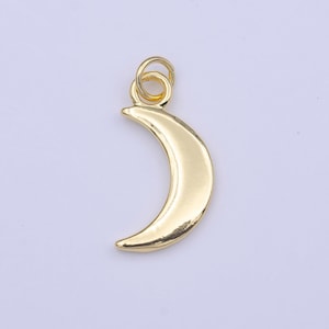 May include: A gold-toned crescent moon charm with a jump ring for attaching to jewelry or other crafts.