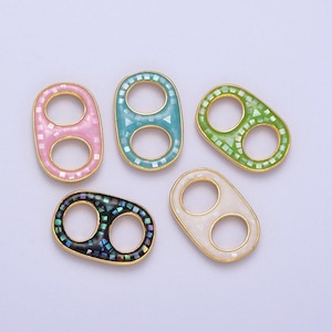 May include: Five double loop connectors with different colored enamel finishes. The connectors are gold-toned and have a geometric pattern.