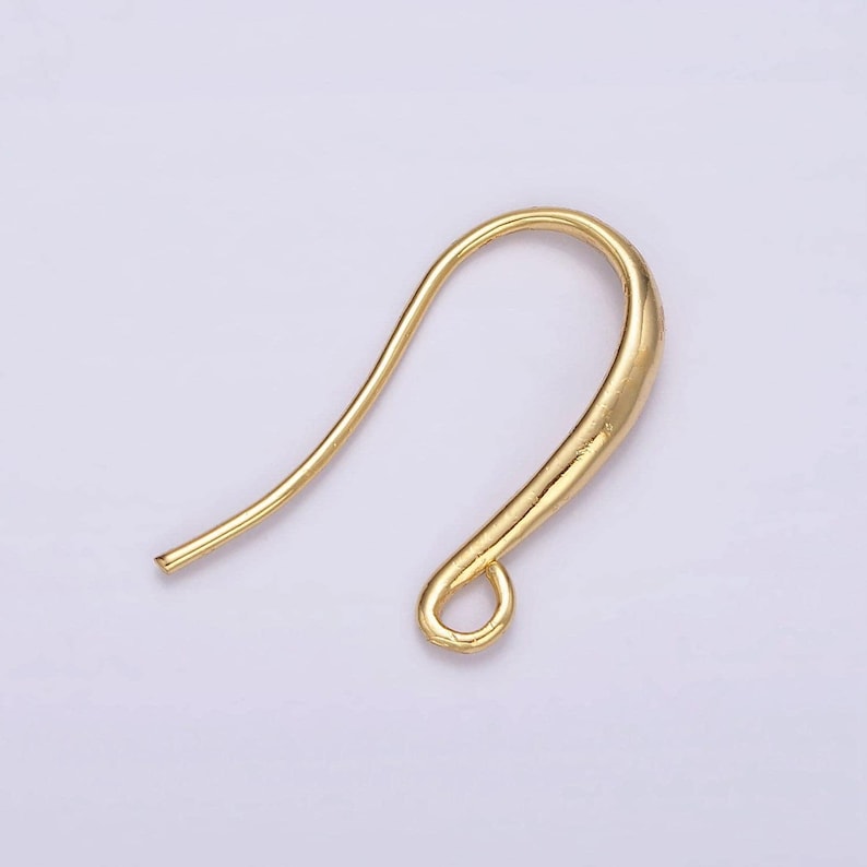 May include: Gold-toned earring hook with a curved wire and a small loop at the end.