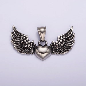 May include: Silver pendant with a heart shape and wings. The heart is smooth and shiny, while the wings are detailed with textured feathers.