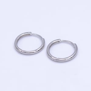 May include: A pair of silver hoop earrings. The earrings are simple and elegant, and they would make a great gift for any occasion.