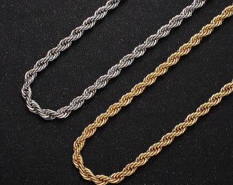 May include: Two gold and silver rope chains on a black background. The chains are made of a thick, twisted rope design.