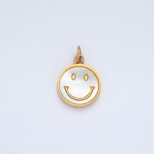 May include: A gold-toned pendant charm featuring a white mother-of-pearl smiley face.