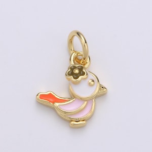 May include: Gold-tone charm featuring a pink and orange bird with a white head and a brown flower on top.