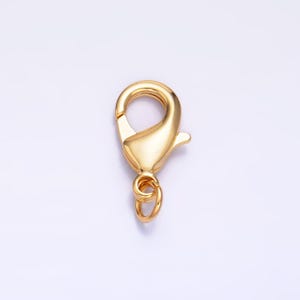 May include: Gold-toned metal lobster clasp with a spring-loaded closure. The clasp is designed for attaching to jewelry or other items.