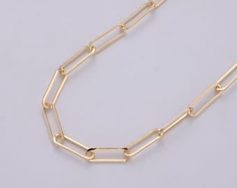 May include: A gold-colored paperclip chain necklace. The necklace features a series of rectangular links connected to each other. The chain is displayed against a light background.